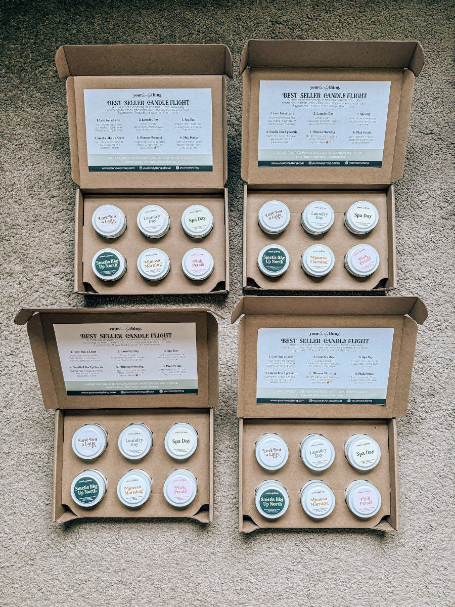 Four cardboard boxes containing small containers with labels on a textured surface