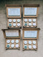 Four cardboard boxes containing small containers with labels on a textured surface