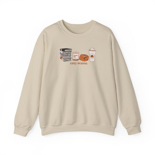 Beige sweatshirt with 'cozy season' graphic on a white background