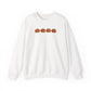 White sweatshirt with four brown pumpkins on a white background