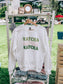 White sweatshirt with 'MATCHA MATCHA MATCHA' text on a hanger outdoors.