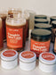 Assorted 'Pumpkin Spice Latte' products including candles and jars on a white surface.